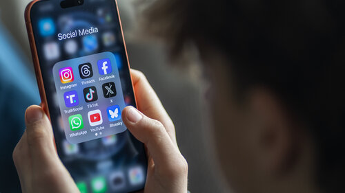 BATH, UNITED KINGDOM - MARCH 29: In this photo illustration a 14-year-old boy holds an iPhone screen displaying various social media and messaging apps on March 29, 2026 in Bath, England. On top row left to right, the logo of social media platform Instagram is seen beside that of Meta’s Threads and Facebook. On the middle row from left is the logo of Donald Trump's Truth Social app, next to the logo of social media app TikTok and the logo of Elon Musk’s US online social media and social networking site 'X' (formerly known as Twitter). Along the bottom row, left to right is the messaging service WhatsApp, the logo for online video sharing and social media platform YouTube and the logo for the Bluesky app. In the UK, a ban on social media for under-16s has been backed by the House of Lords following the Australian law which aims to stop children under 16 from having social media accounts and social media platforms, including TikTok, Facebook, Snapchat, Reddit, X, formerly Twitter, and Instagram potentially being be fined for preventing children younger than 16 from having social media accounts. (Photo by Anna Barclay/Getty Images) BATH, UNITED KINGDOM - MARCH 29: In this photo illustration a 14-year-old boy holds an iPhone screen displaying various social media and messaging apps on March 29, 2026 in Bath, England. On top row left to right, the logo of social media platform Instagram is seen beside that of Meta’s Threads and Facebook. On the middle row from left is the logo of Donald Trump's Truth Social app, next to the logo of social media app TikTok and the logo of Elon Musk’s US online social media and social networking site 'X' (formerly known as Twitter). Along the bottom row, left to right is the messaging service WhatsApp, the logo for online video sharing and social media platform YouTube and the logo for the Bluesky app. In the UK, a ban on social media for under-16s has been backed by the House of Lords following the Australian law which aims to stop children under 16 from having social media accounts and social media platforms, including TikTok, Facebook, Snapchat, Reddit, X, formerly Twitter, and Instagram potentially being be fined for preventing children younger than 16 from having social media accounts. (Photo by Anna Barclay/Getty Images)