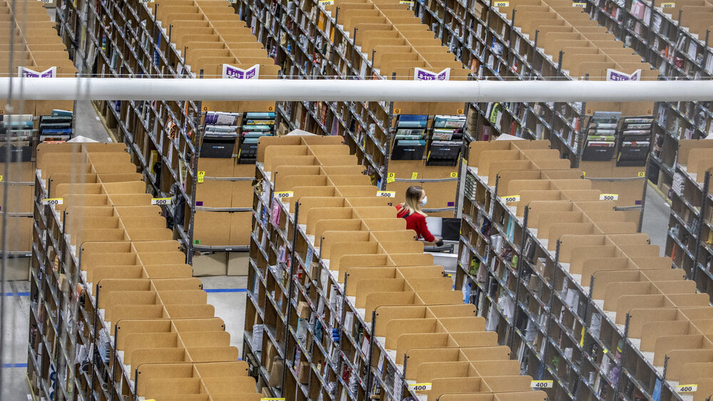 BRIESELANG, GERMANY - NOVEMBER 18: A worker pushes a cart laden with ordered items among shelves at an Amazon warehouse on November 18, 2021 in Brieselang, Germany. Many shoppers who fear gifts will be lacking due to the global supply chain disruption are buying their Christmas gifts early this year, both online and at brick and mortar retailers. (Photo by Maja Hitij/Getty Images) BRIESELANG, GERMANY - NOVEMBER 18: A worker pushes a cart laden with ordered items among shelves at an Amazon warehouse on November 18, 2021 in Brieselang, Germany. Many shoppers who fear gifts will be lacking due to the global supply chain disruption are buying their Christmas gifts early this year, both online and at brick and mortar retailers. (Photo by Maja Hitij/Getty Images)