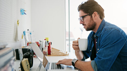 Shot of a man doing some from from home on his laptop Shot of a man doing some from from home on his laptop
