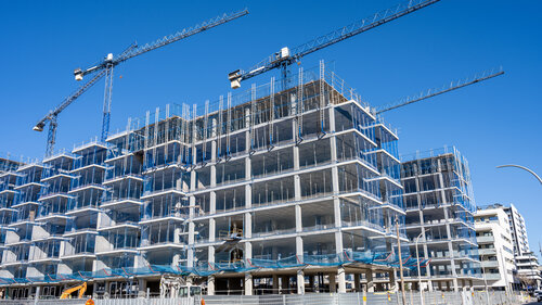Construction site with cranes for residential buildings